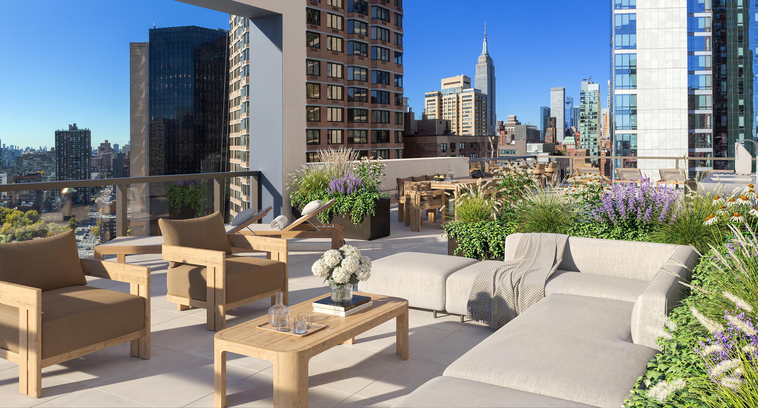 Rooftop terrace at The Lotus NYC in Murray Hill featuring outdoor seating and iconic Manhattan skyline views.